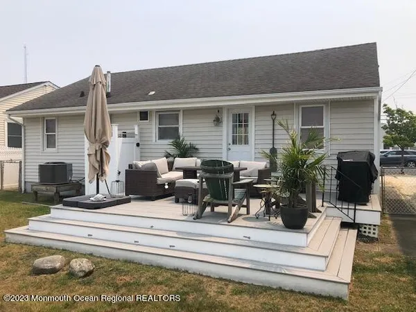 a view of a house with backyard porch and sitting area