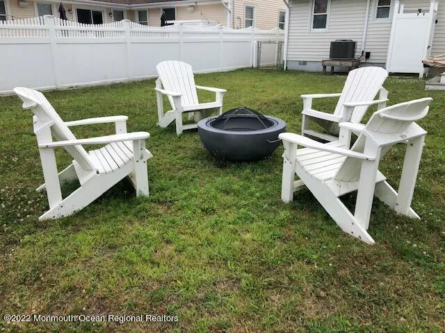 a view of backyard of house with outdoor seating and green space