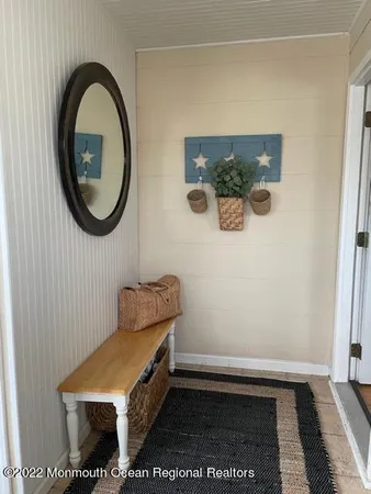 a room with a small mirror and a window