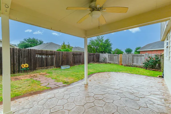a view of an house with backyard and sitting area
