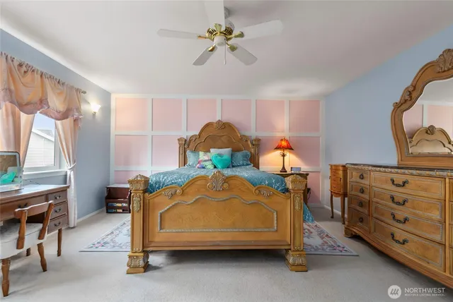 a bedroom with a bed and a chandelier