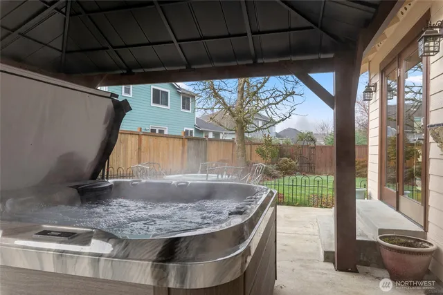 a view of a backyard with table and chairs under an umbrella
