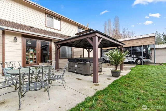 a view of a backyard with a patio and outdoor seating