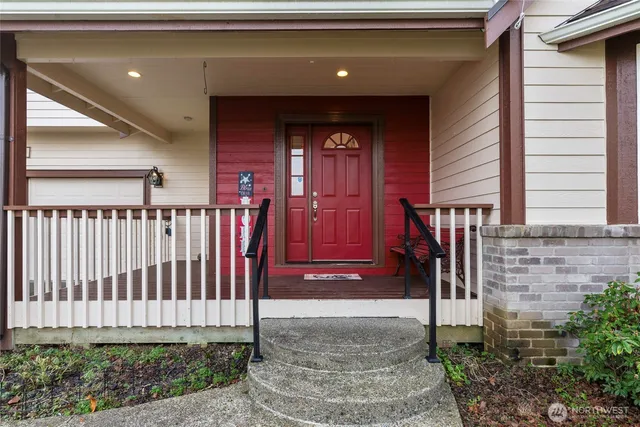 a view of a house with a small yard and wooden floor and fence
