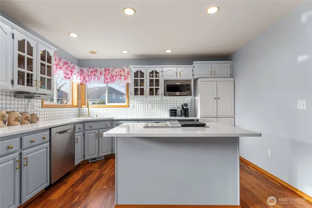 a kitchen with stainless steel appliances granite countertop a sink and cabinets