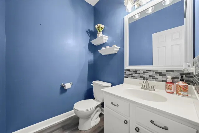 a bathroom with a toilet a sink and mirror