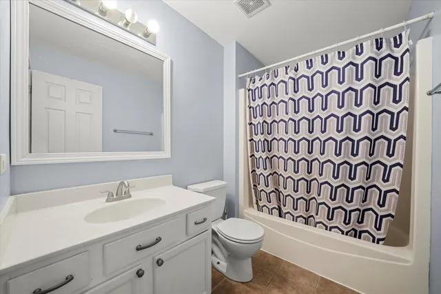 a bathroom with a shower curtain sink and a mirror