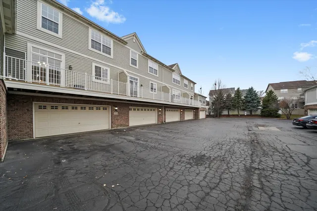 a white bench sitting in front of a building