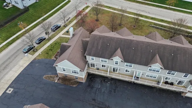 an aerial view of multiple houses with yard