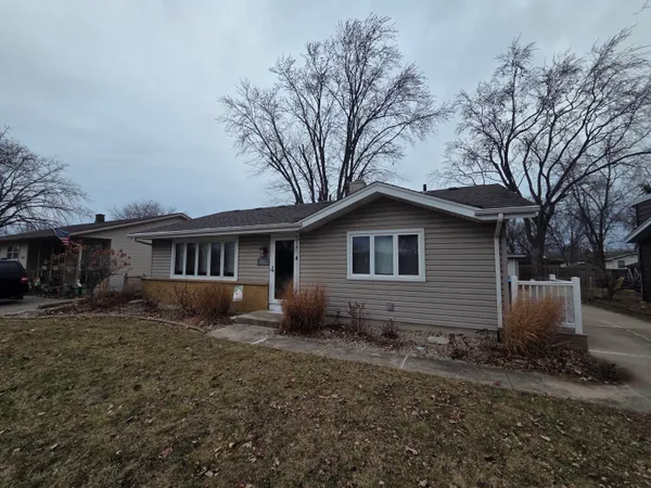 a house that has a tree in front of it