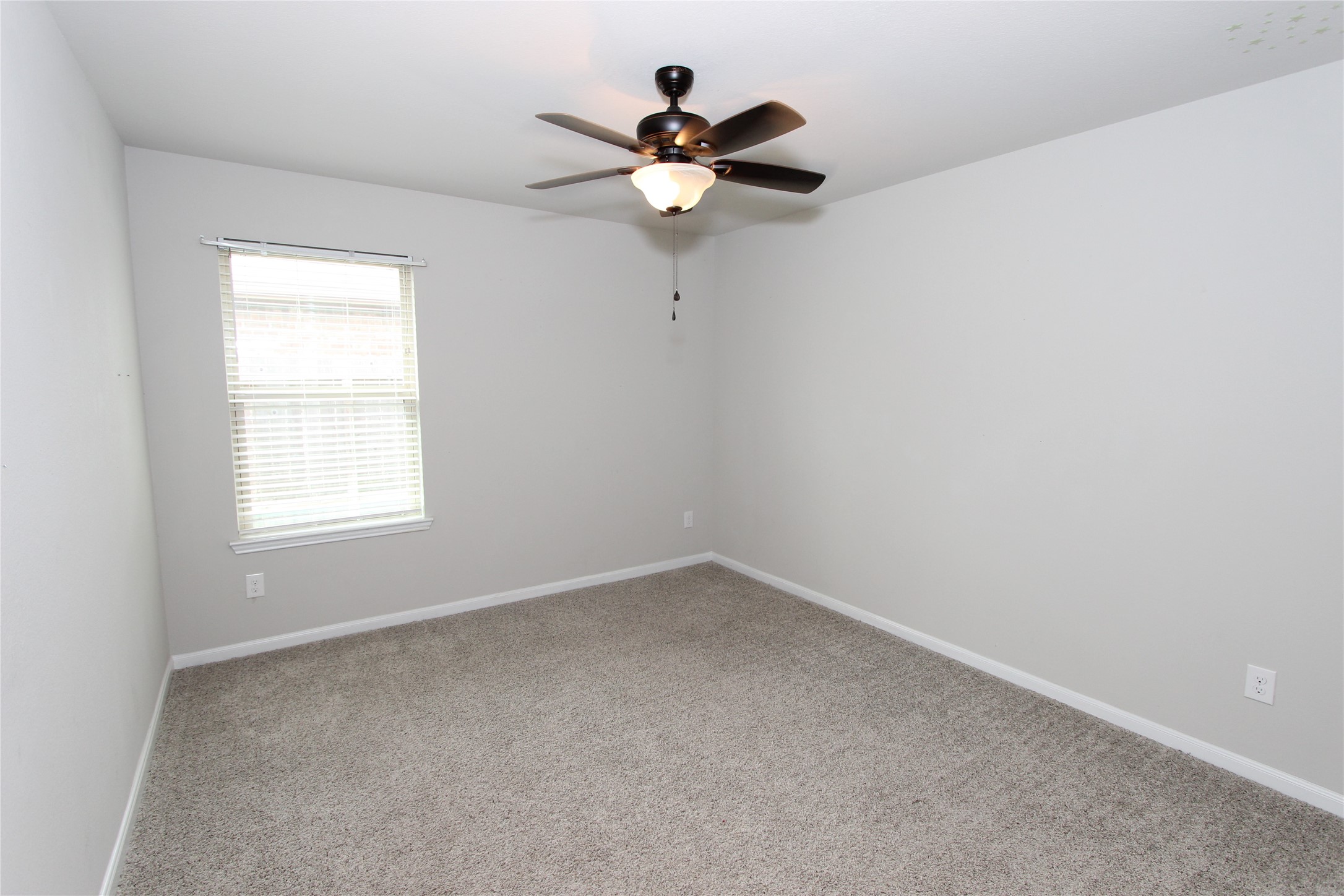 1303 Keaton Court Rosenberg, TX 77469 - Photo 17 of 22 an empty room with a window and a fan