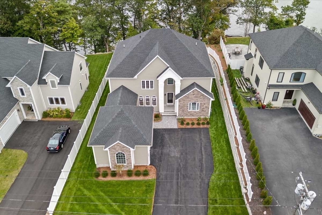 an aerial view of a house with a yard
