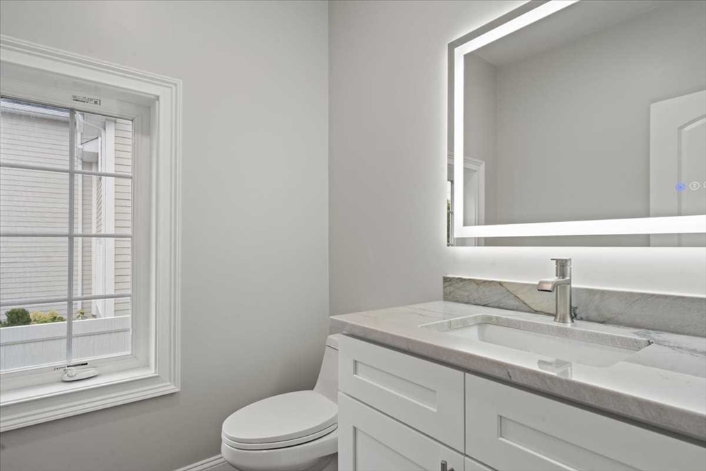 241 Lake Avenue Worcester, MA 01604 - Photo 18 of 42 a bathroom with a granite countertop sink toilet a mirror and shower