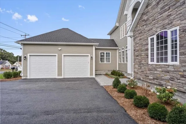 a front view of a house with a yard and garage