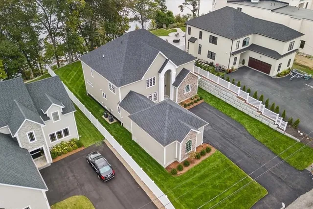 an aerial view of a house with a big yard