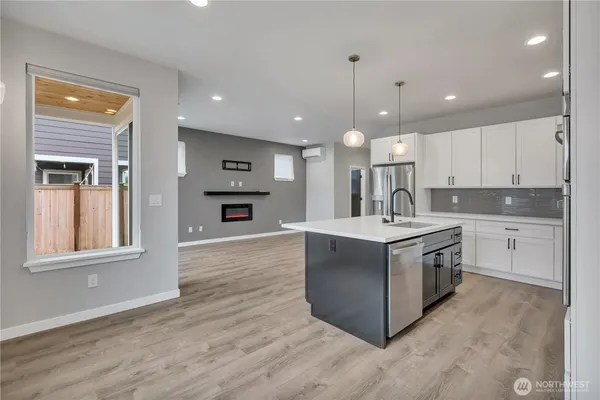a kitchen with stainless steel appliances granite countertop a sink a stove and a refrigerator