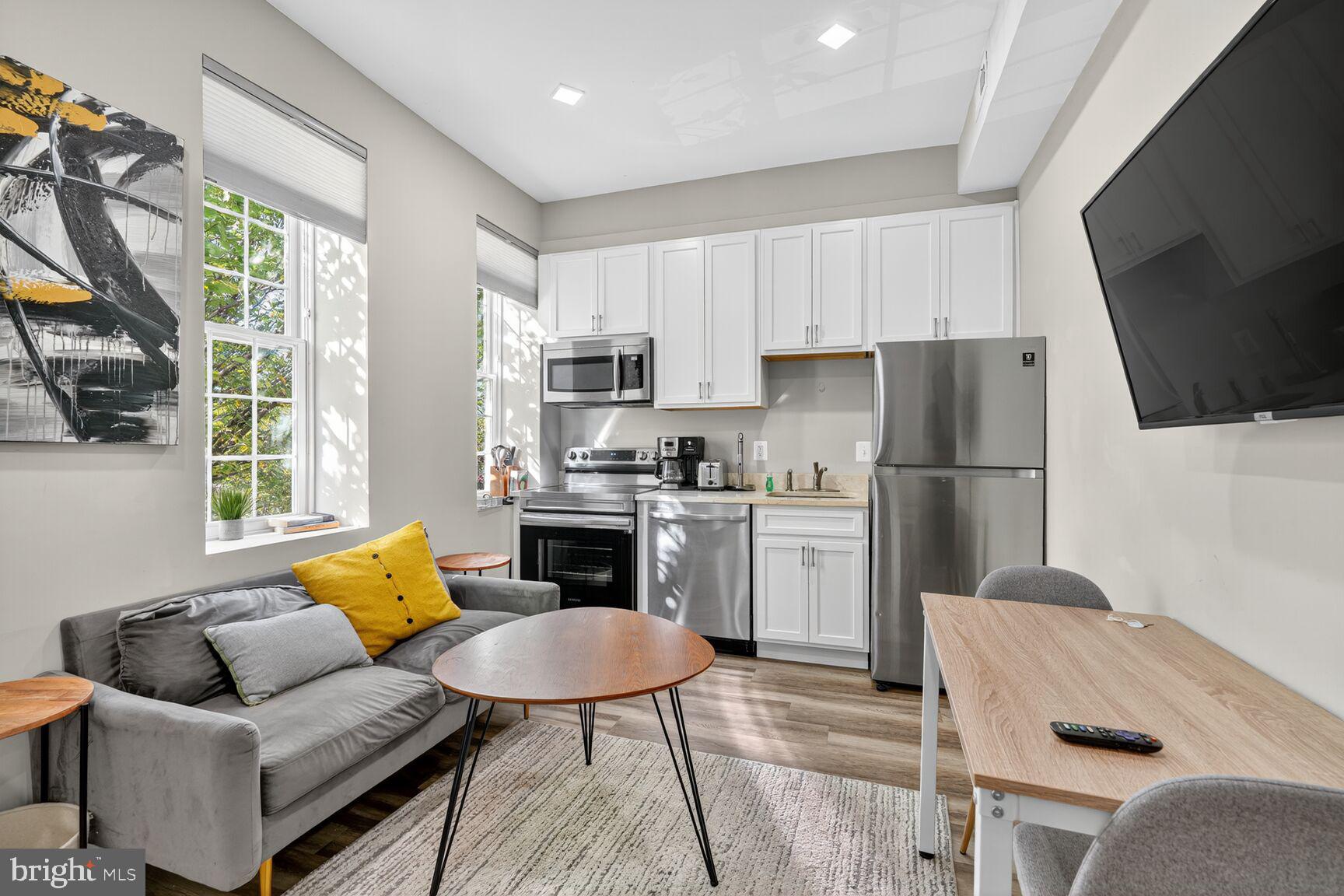 133 7th Street Southeast, Unit 1 Washington, DC 20003 - Photo 12 of 13 a kitchen with white cabinets and stainless steel appliances