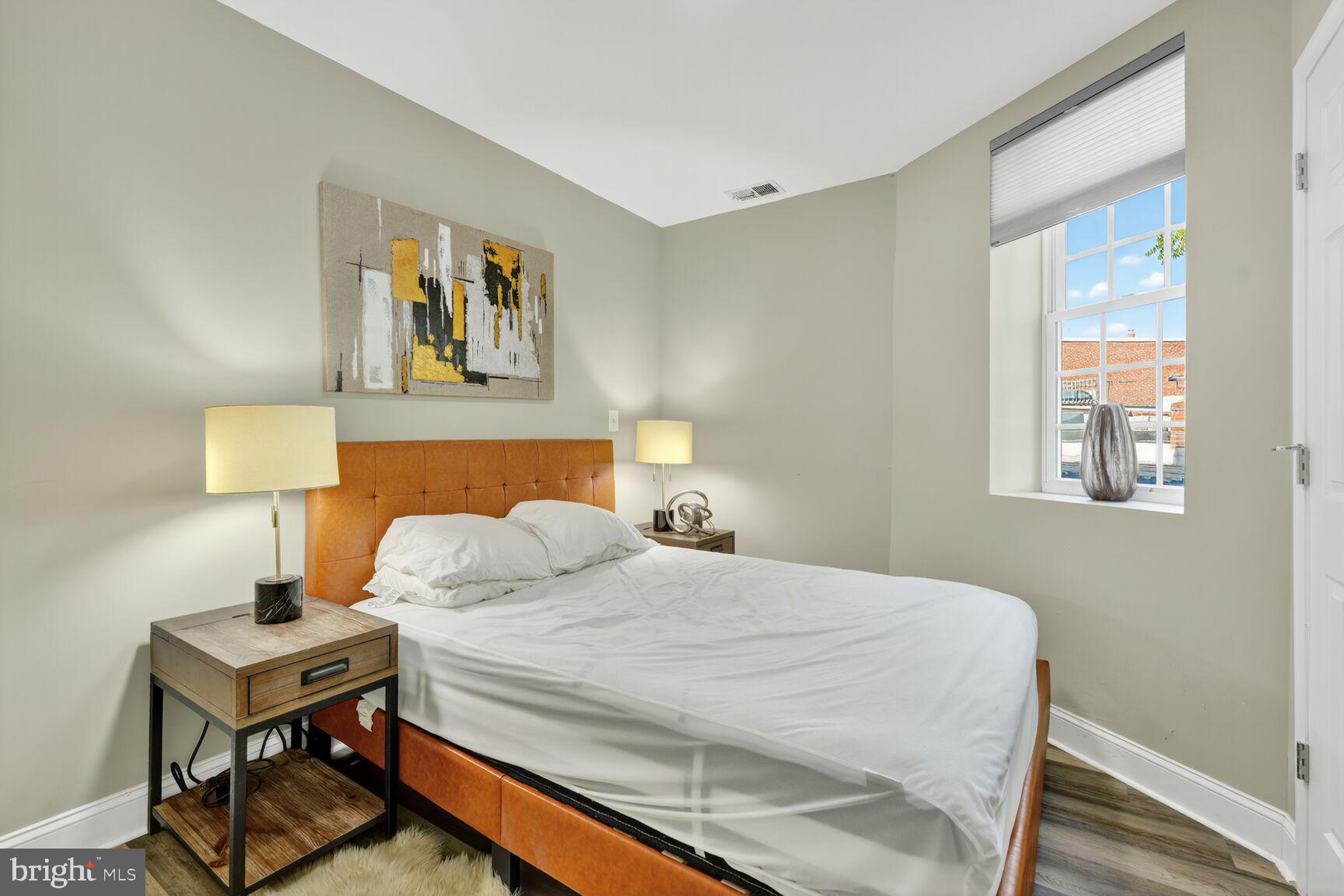 133 7th Street Southeast, Unit 1 Washington, DC 20003 - Photo 8 of 13 a bedroom with a bed and a table in it