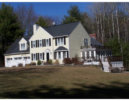 396 Hudson Road Stow, MA 01775 - Photo 3 of 12 a front view of a house with a garden