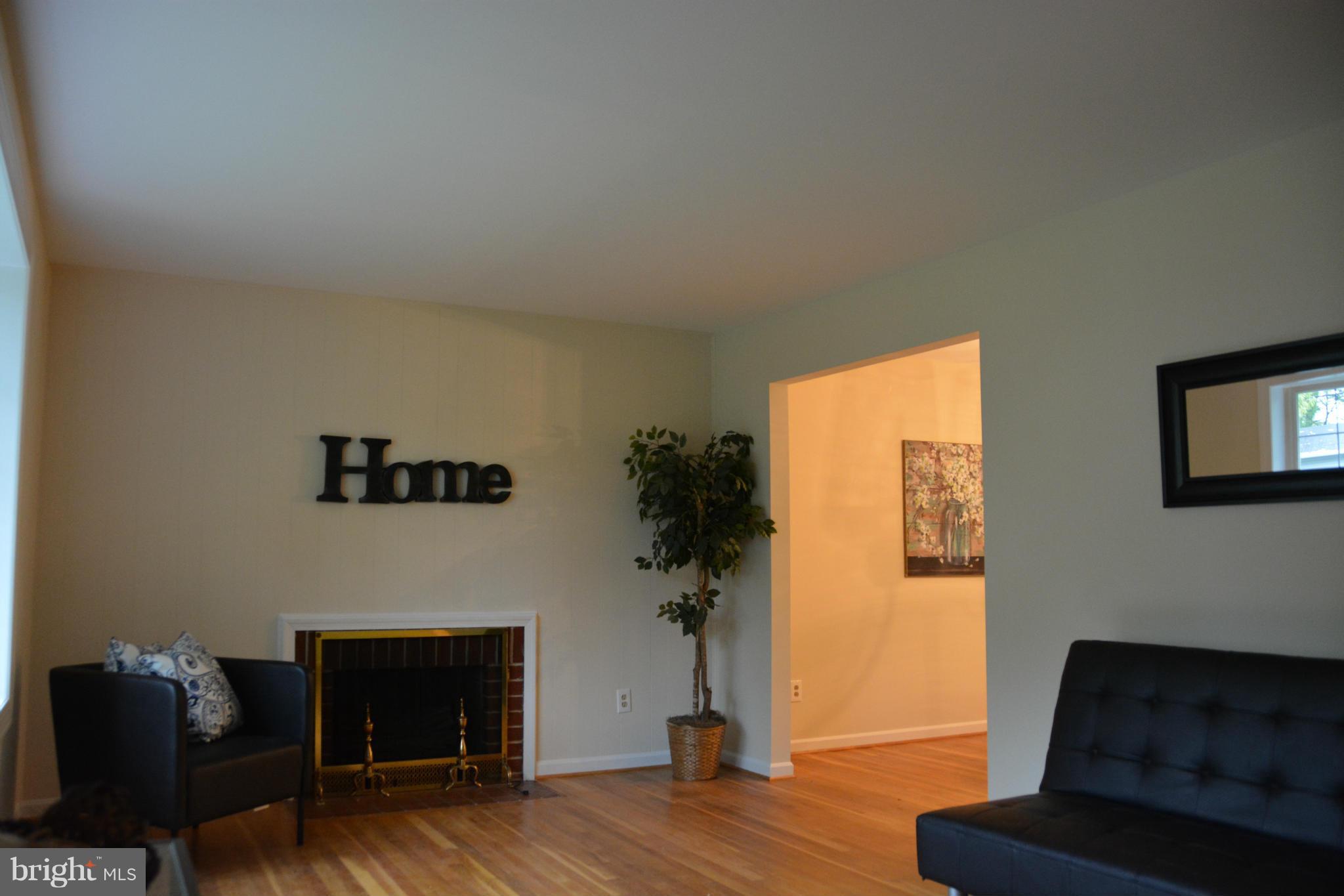 8702 Clydesdale Road Springfield, VA 22151 - Photo 3 of 17 a living room with furniture and a fireplace