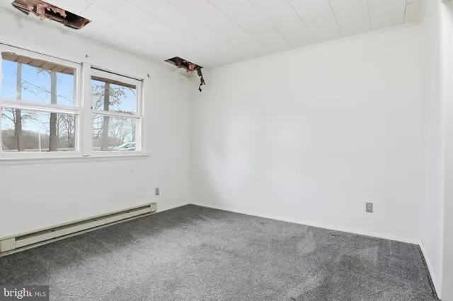 a view of a big room with windows and closet