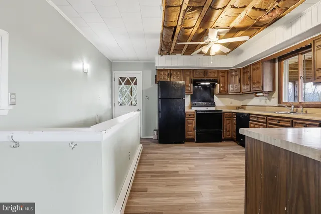 a large kitchen with stainless steel appliances granite countertop a stove and cabinets