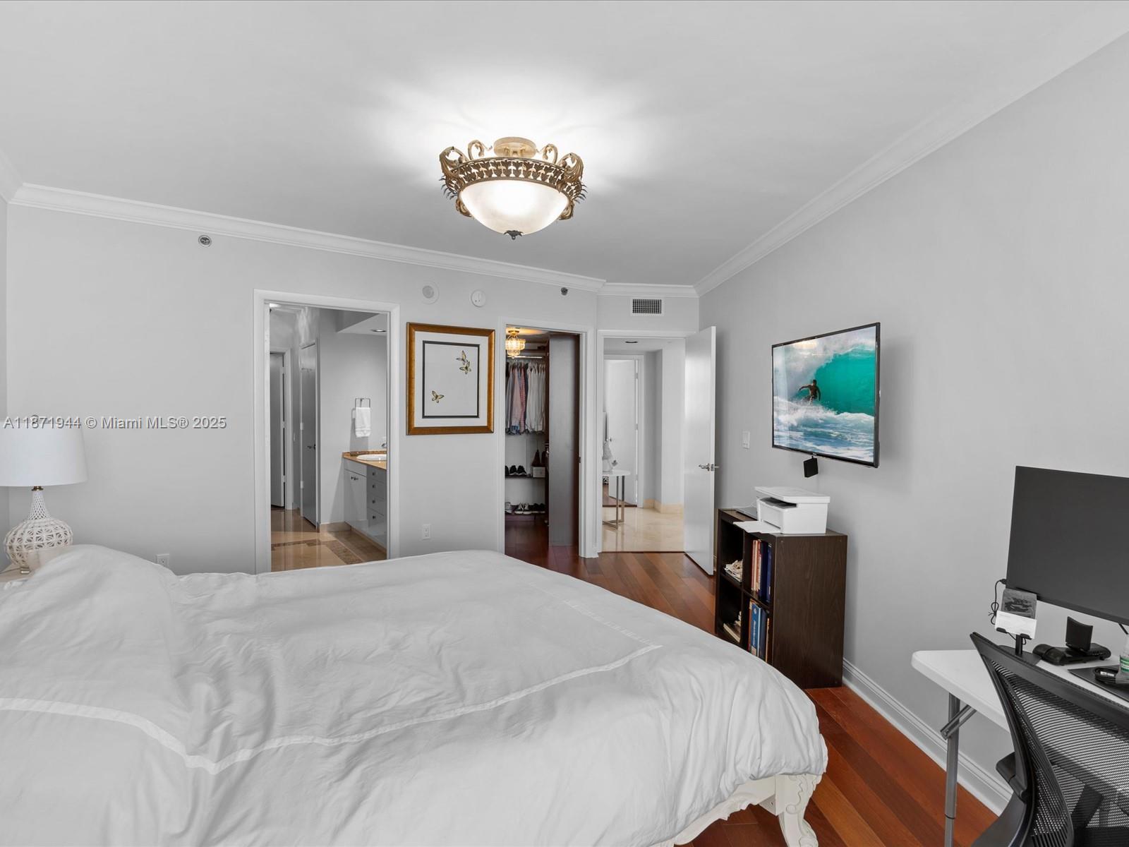 19111 Collins Avenue, Unit 1406 Sunny Isles Beach, FL 33160 - Photo 21 of 40 a bedroom with a bed and a flat screen tv