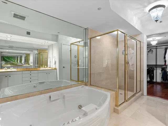 a bathroom with a bathtub and a shower