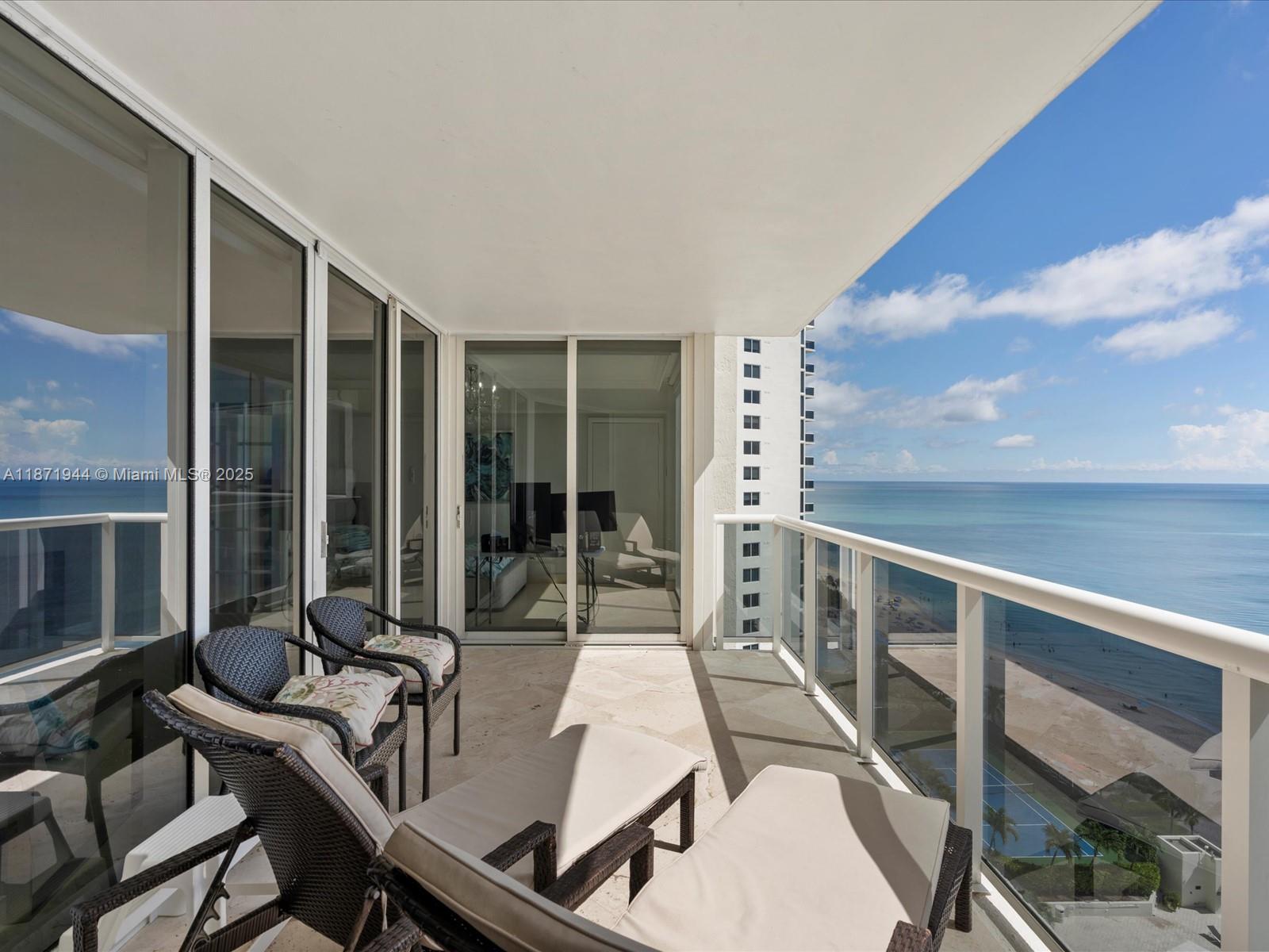 19111 Collins Avenue, Unit 1406 Sunny Isles Beach, FL 33160 - Photo 30 of 40 a balcony with table and chairs