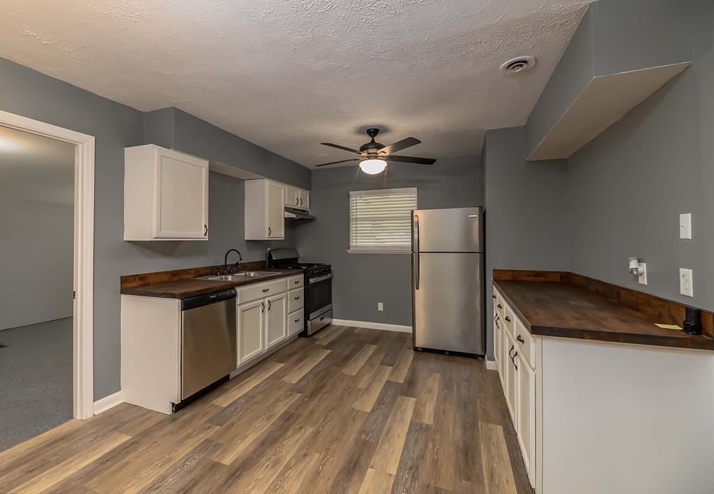 2127 Lamore Drive Columbus, GA 31907 - Photo 5 of 8 a kitchen with a refrigerator and a stove top oven