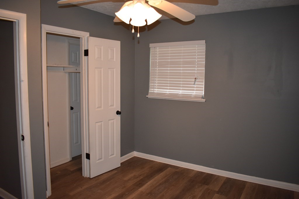 2127 Lamore Drive Columbus, GA 31907 - Photo 8 of 8 a view of an empty room with wooden floor and a window