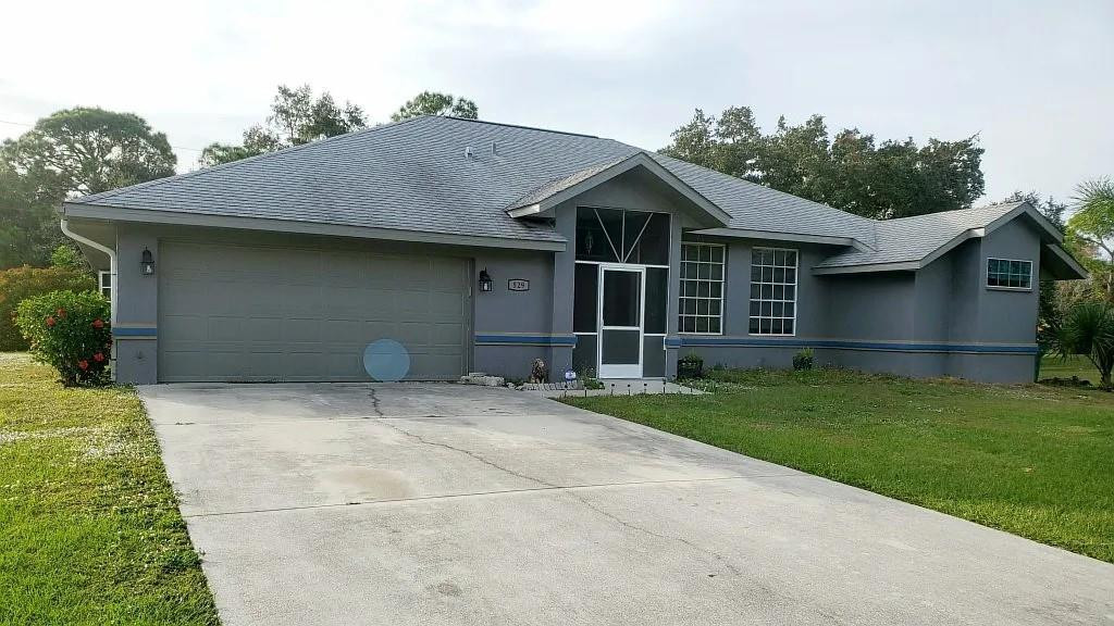 529 Guild Street Port Charlotte, FL 33954 - Photo 1 of 41 a front view of a house with a garden