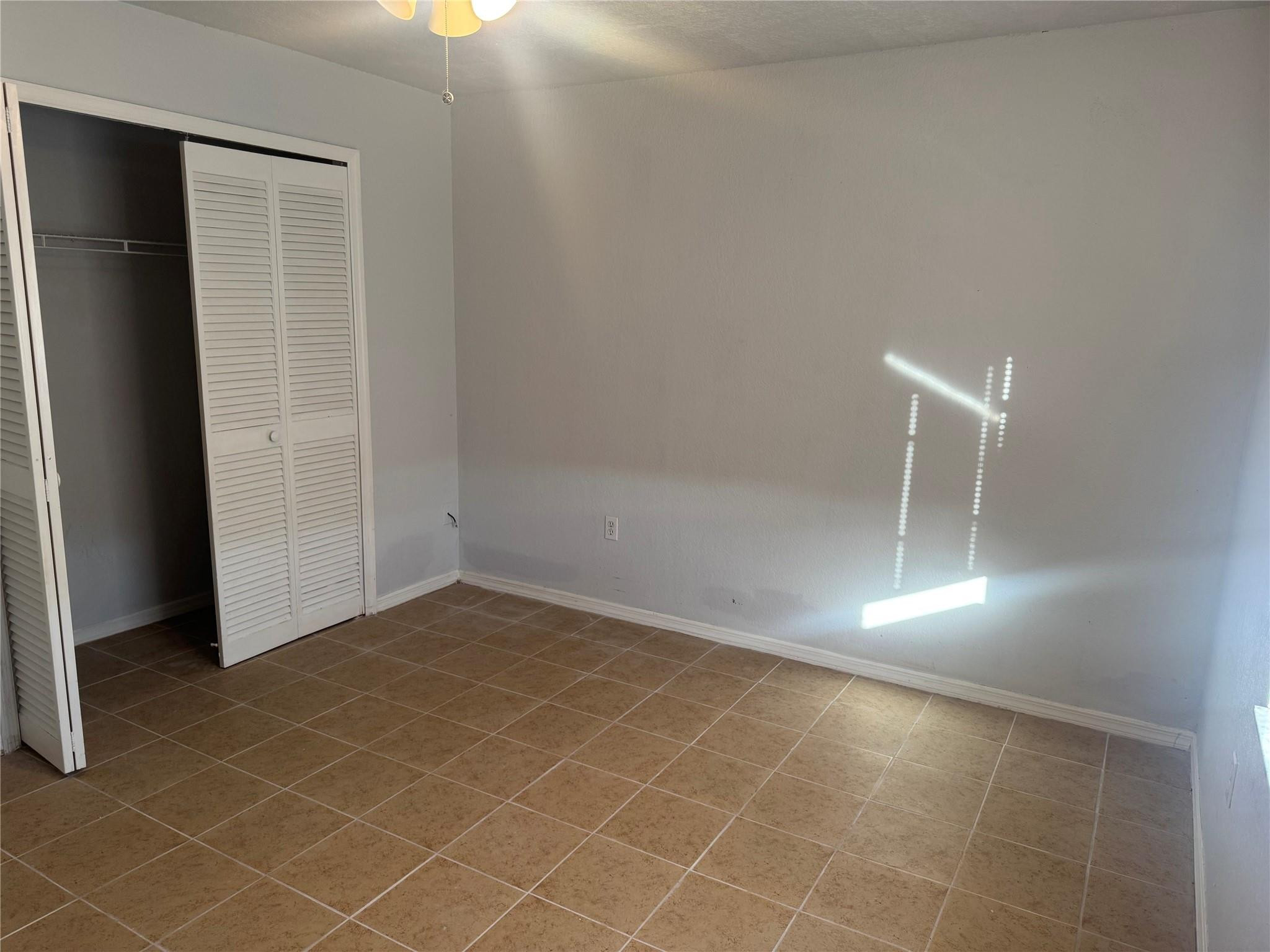 529 Guild Street Port Charlotte, FL 33954 - Photo 17 of 41 an empty room with wooden floor and windows
