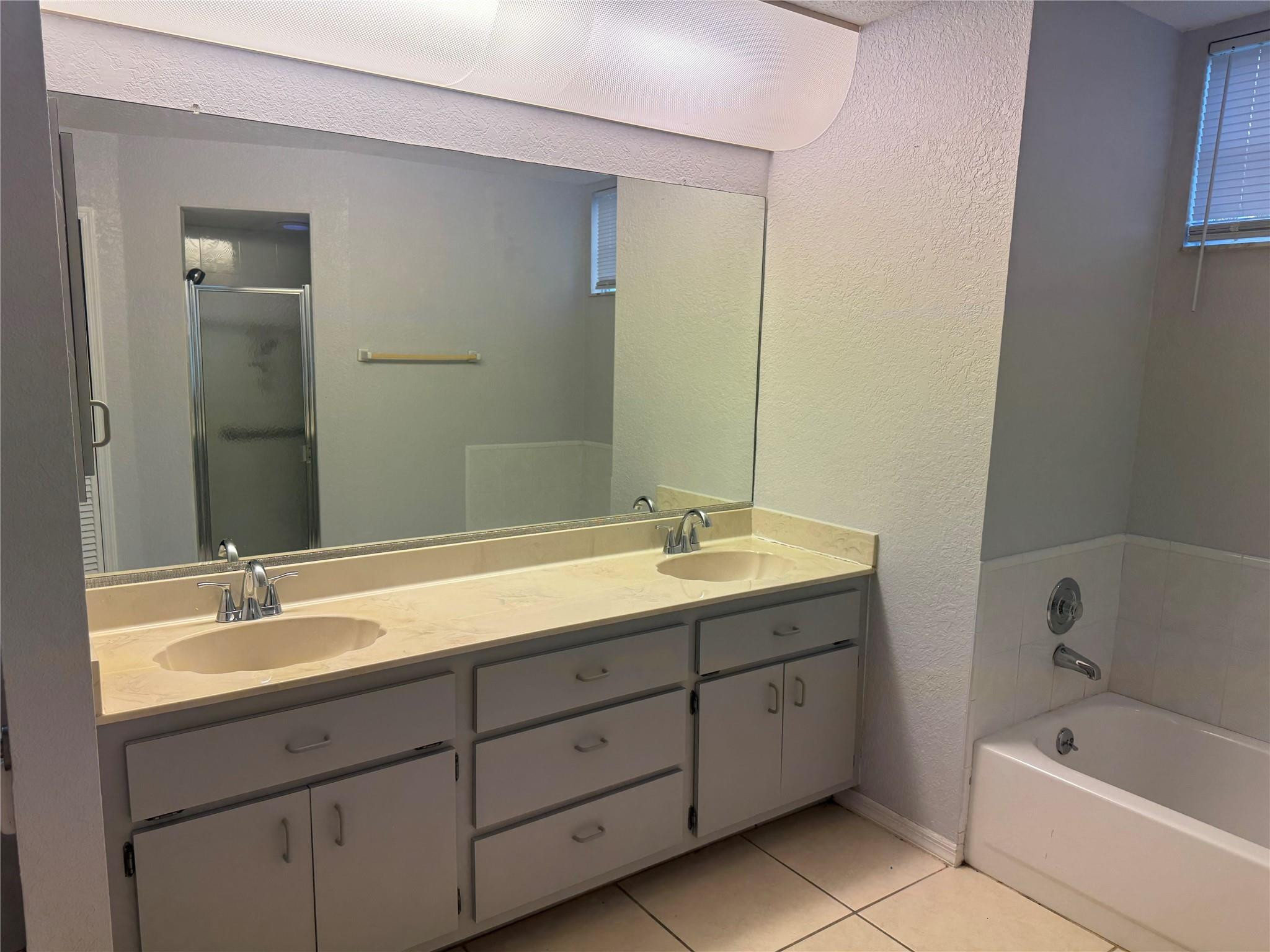 529 Guild Street Port Charlotte, FL 33954 - Photo 22 of 41 a bathroom with a double vanity sink and mirror with bathtub