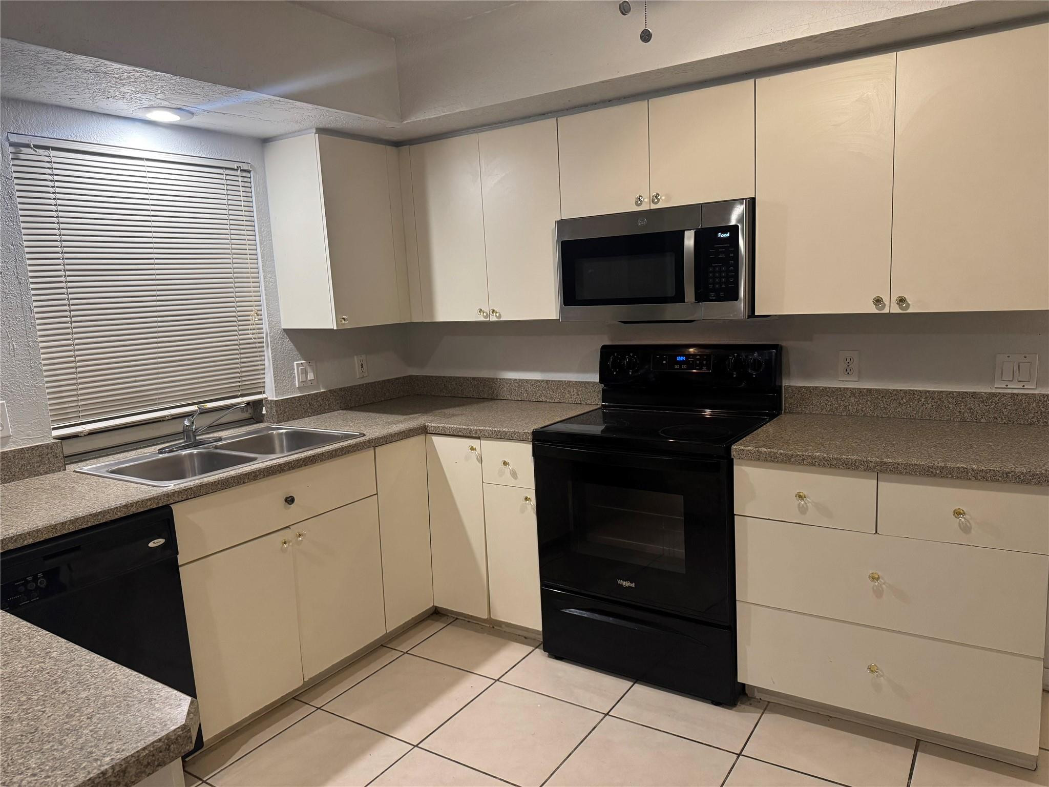 529 Guild Street Port Charlotte, FL 33954 - Photo 39 of 41 a kitchen with stainless steel appliances granite countertop a sink and a stove