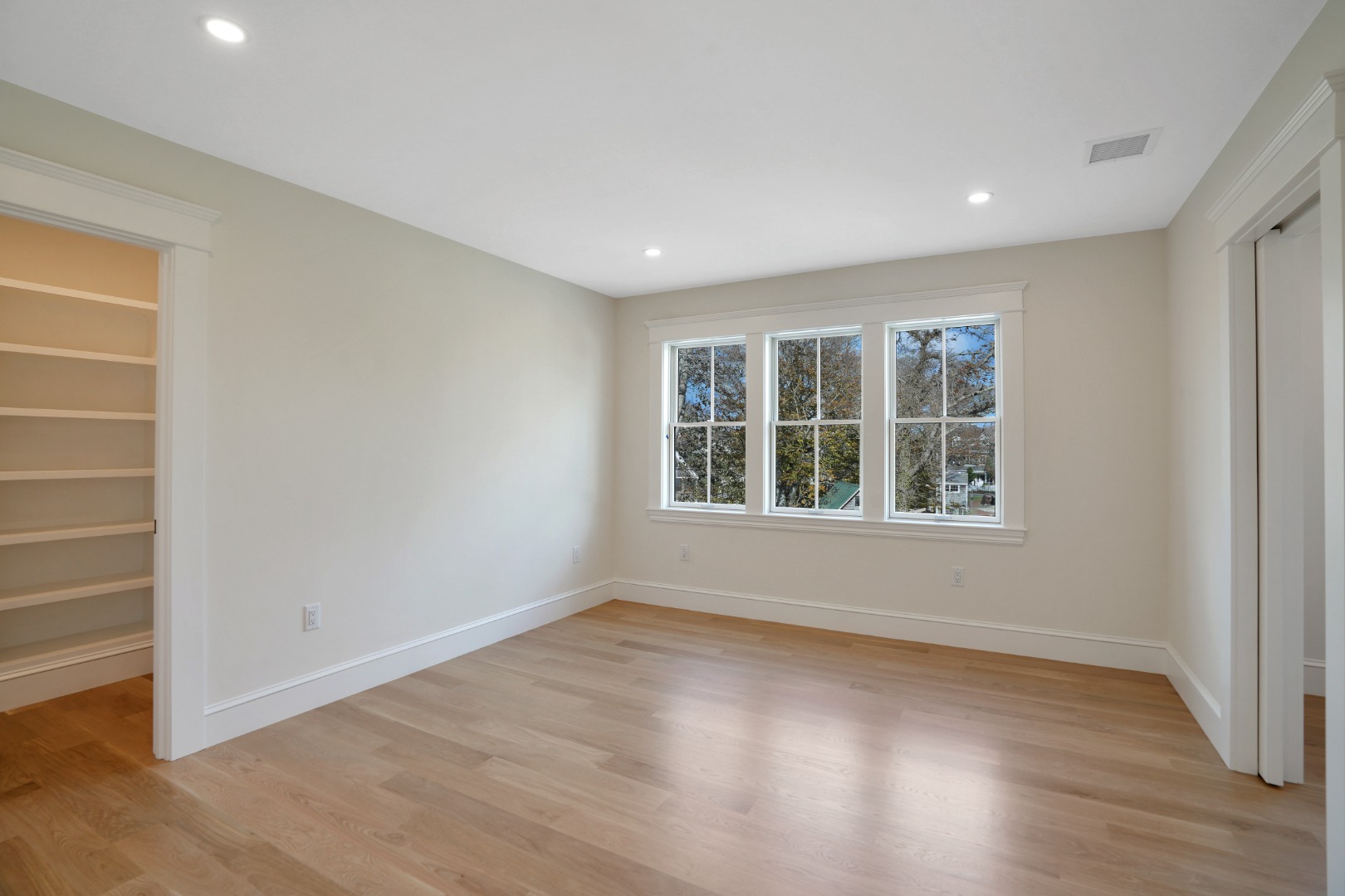23 Pinehurst Road Edgartown, MA 02539 - Photo 45 of 57 an empty room with wooden floor and windows