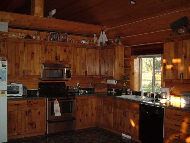 155512 West Johnson Road Prosser, WA 99350 - Photo 4 of 6 a kitchen with granite countertop a stove a sink and a microwave