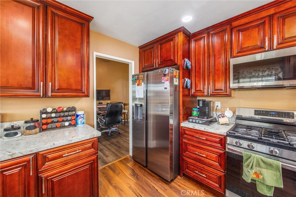 10399 Monte Vista Street Rancho Cucamonga, CA 91701 - Photo 14 of 43 a kitchen with stainless steel appliances granite countertop a refrigerator stove and sink