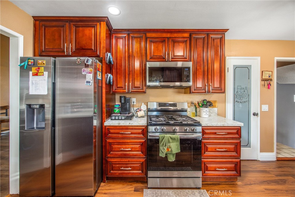 10399 Monte Vista Street Rancho Cucamonga, CA 91701 - Photo 15 of 43 a kitchen with stainless steel appliances granite countertop a refrigerator microwave and stove