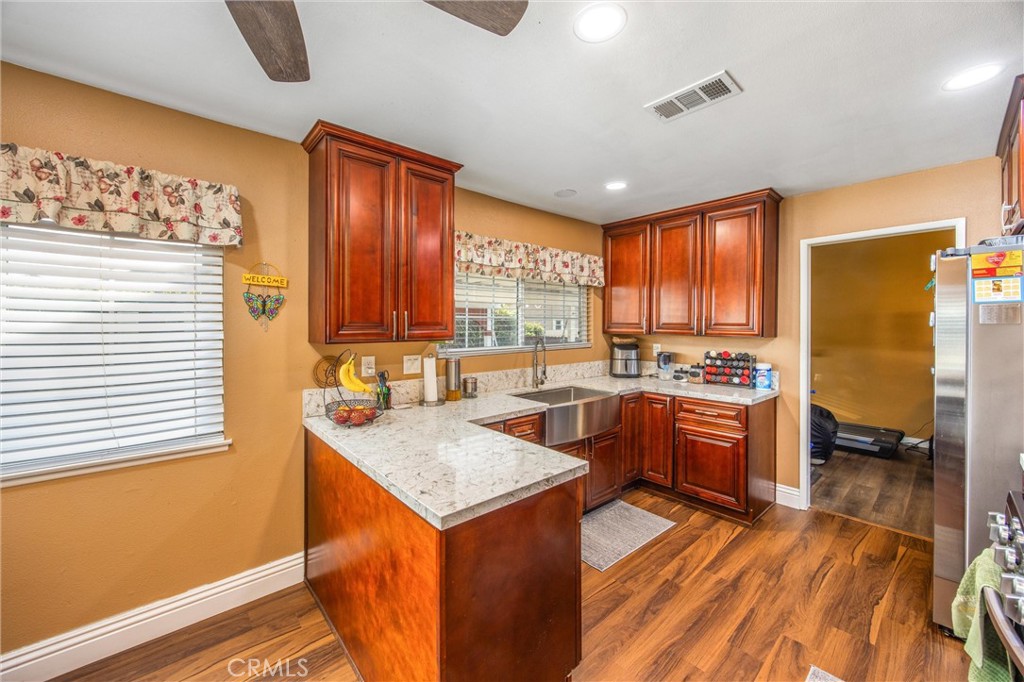10399 Monte Vista Street Rancho Cucamonga, CA 91701 - Photo 18 of 43 a kitchen with stainless steel appliances granite countertop sink stove top oven and cabinets