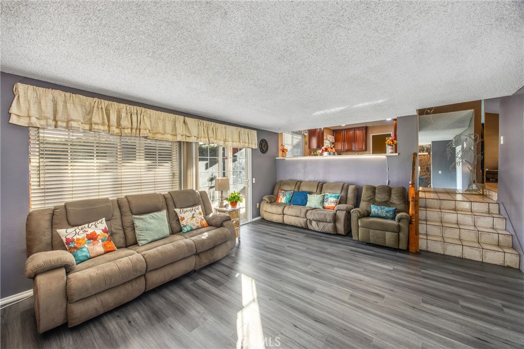 10399 Monte Vista Street Rancho Cucamonga, CA 91701 - Photo 22 of 43 a living room with furniture and a floor to ceiling window