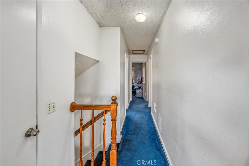 10399 Monte Vista Street Rancho Cucamonga, CA 91701 - Photo 27 of 43 a view of a hallway with wooden floor and staircase