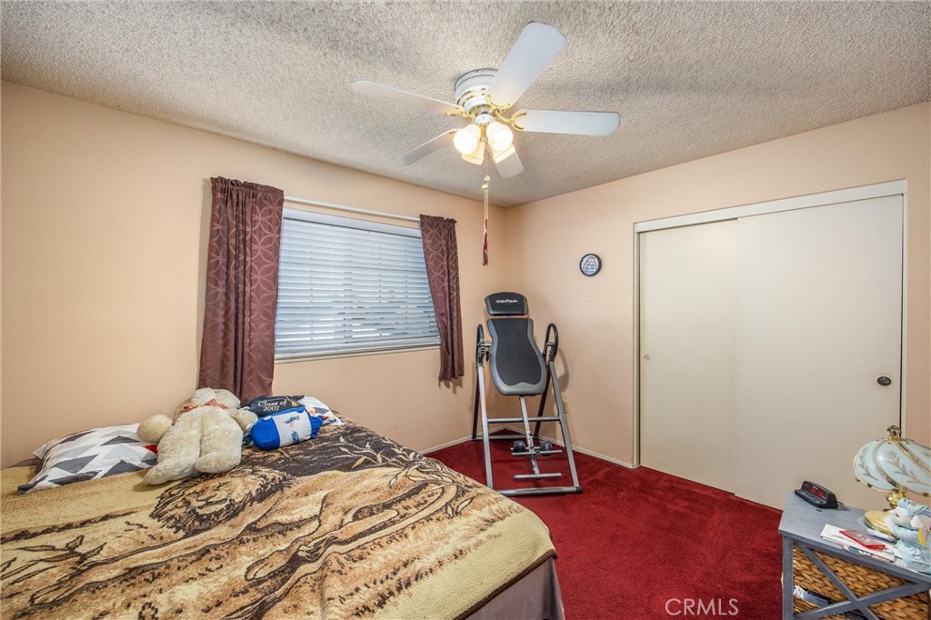 10399 Monte Vista Street Rancho Cucamonga, CA 91701 - Photo 30 of 43 a bedroom with a bed and a chandelier