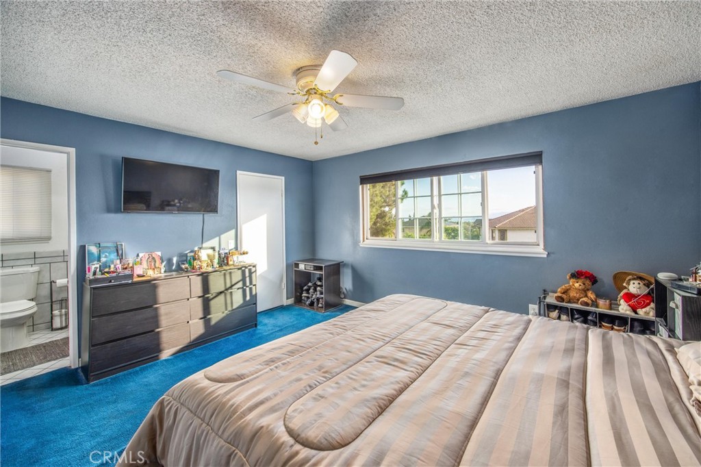 10399 Monte Vista Street Rancho Cucamonga, CA 91701 - Photo 32 of 43 a bedroom with a bed and a chandelier