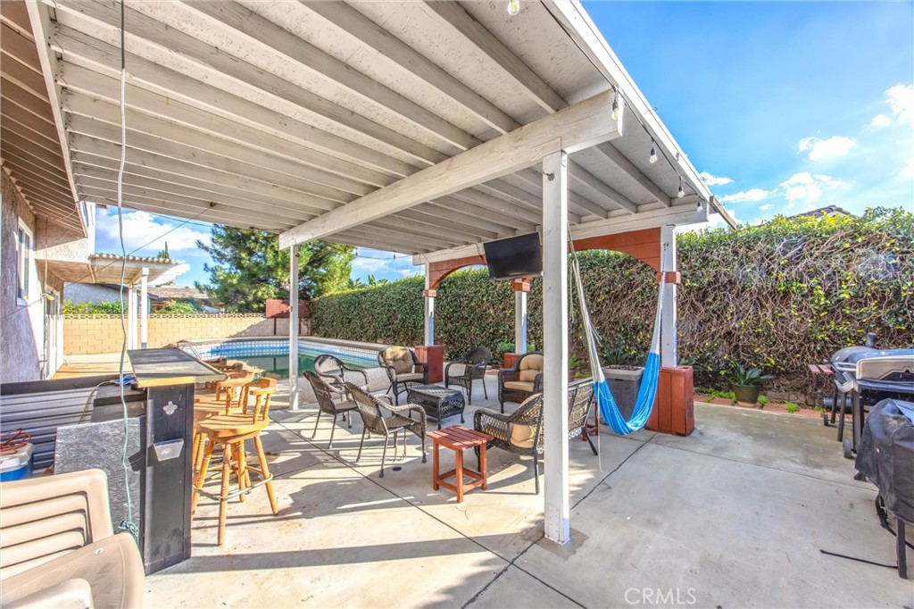 10399 Monte Vista Street Rancho Cucamonga, CA 91701 - Photo 41 of 43 a view of a patio with a dining table and chairs under an umbrella