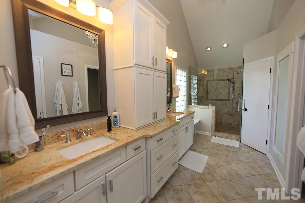 4100 Stemmons Court Raleigh, NC 27613 - Photo 9 of 13 a spacious bathroom with double sink and a large mirror