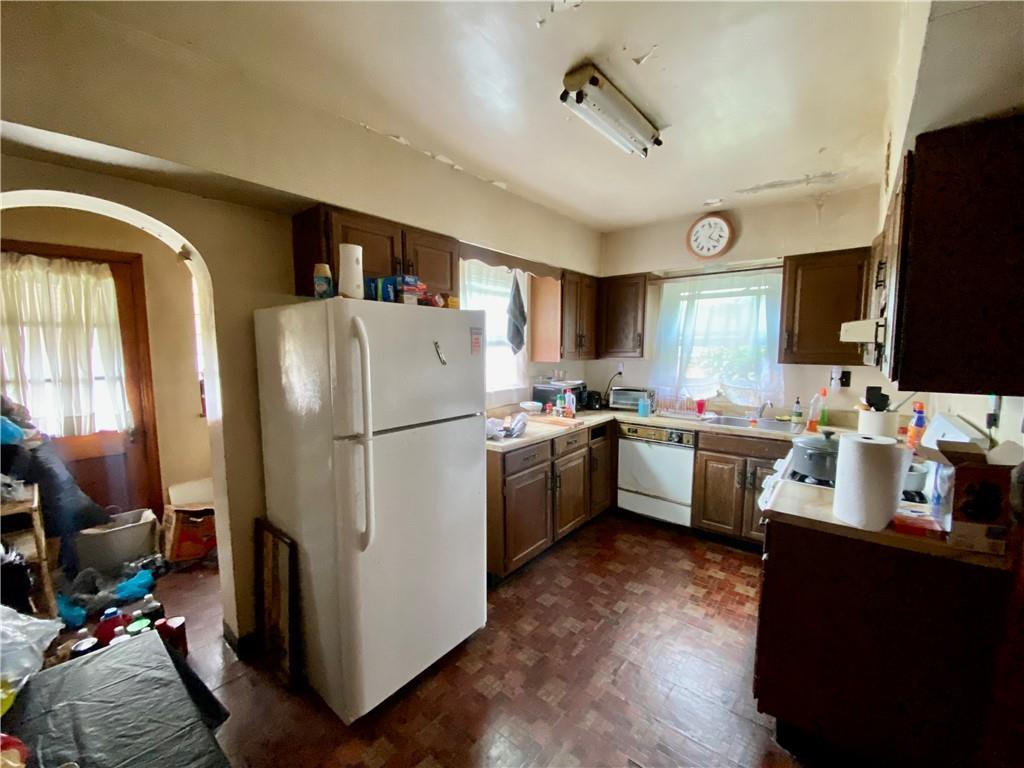 1590 Old Brodhead Road Monaca, PA 15061 - Photo 11 of 29 a kitchen with a refrigerator a sink dishwasher and a stove with wooden floor