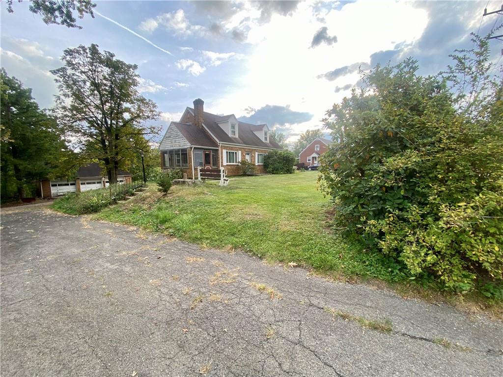 1590 Old Brodhead Road Monaca, PA 15061 - Photo 4 of 29 a front view of a house with a yard and trees