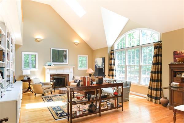 65 Lincoln Road Sudbury, MA 01776 - Photo 2 of 24 a living room with fireplace furniture and a floor to ceiling window