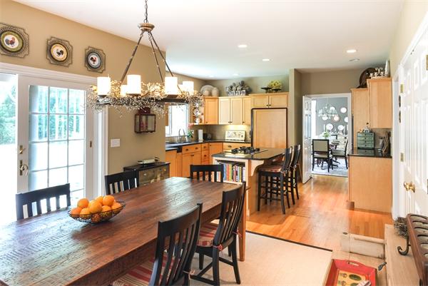 65 Lincoln Road Sudbury, MA 01776 - Photo 10 of 24 a view of a dining room and livingroom with furniture wooden floor a chandelier